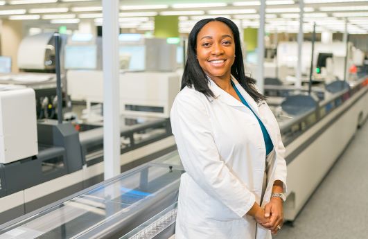 ADLM President Dr. Octavia Peck Palmer stands in the middle of her lab.