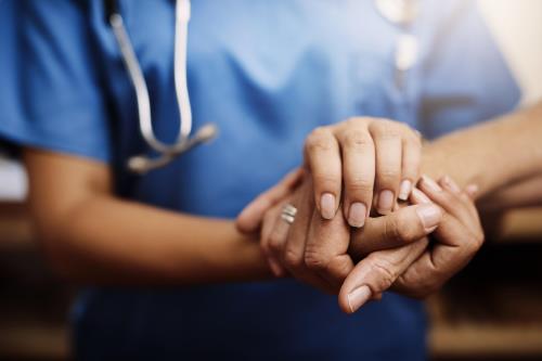 HIV physician holding patient's hand