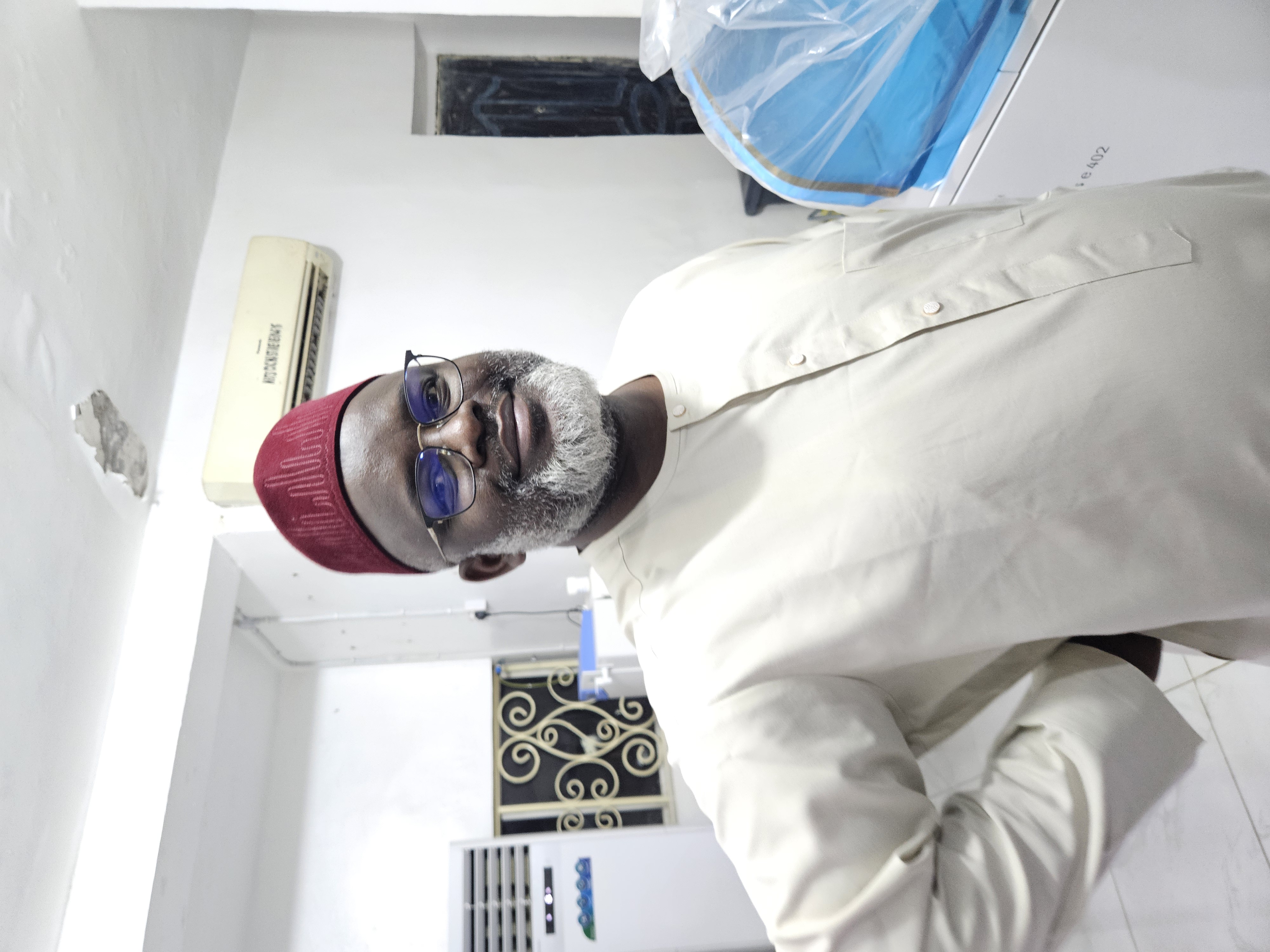 Professor Saleh Yuguda, MBBS, FMCPath, smiling at the camera at a laboratory