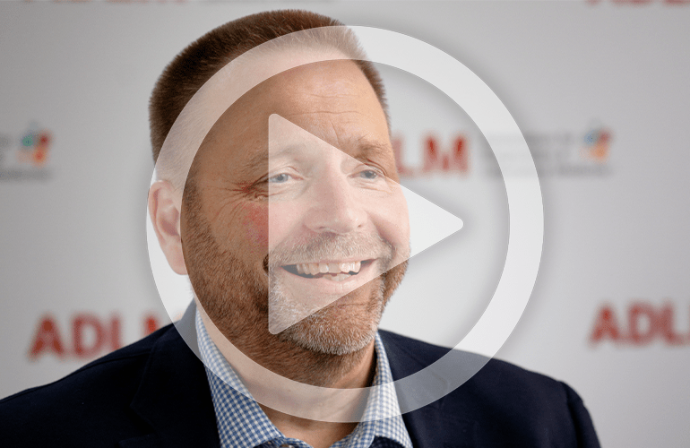 Dr. Dennis Dietzen pictured with a graphic of a play button superimposed