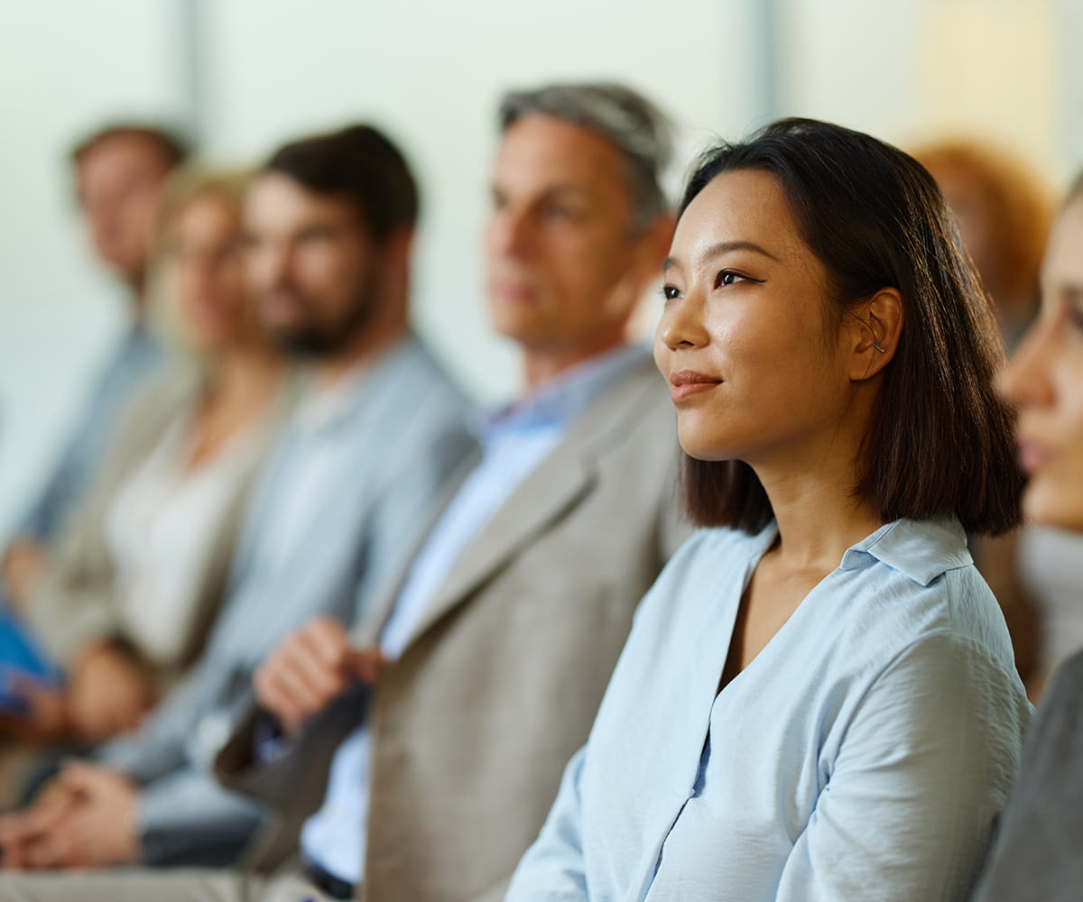 Audience members watching a presentation