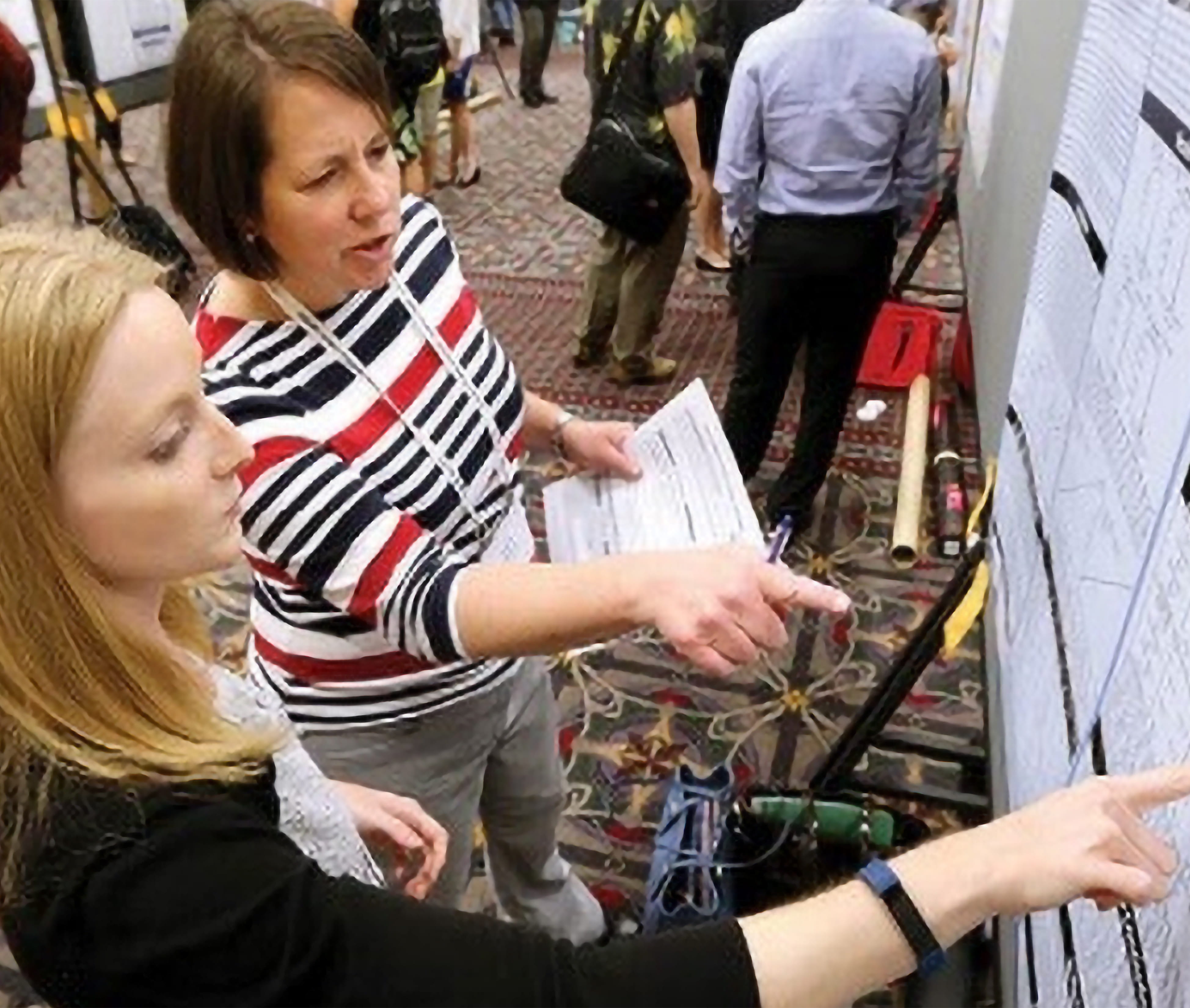 two women looking at poster at ADLM Scientific Meeting and Expo