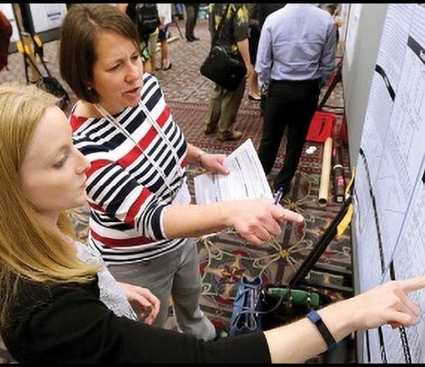 two women looking at poster at ADLM Scientific Meeting and Expo