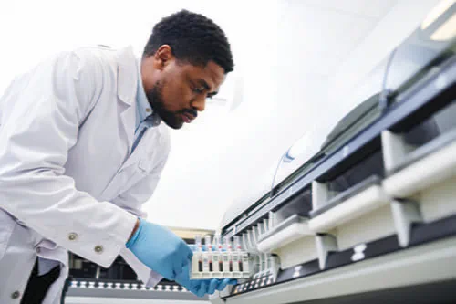 An African American male working with lab equpiment