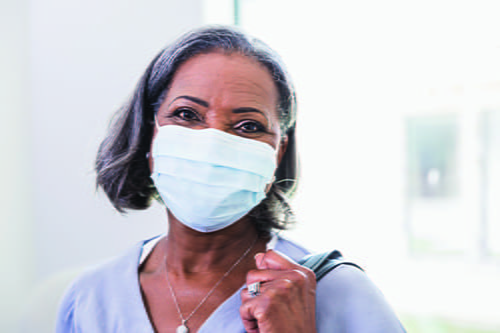 A headshot of an African American woman in a mask.