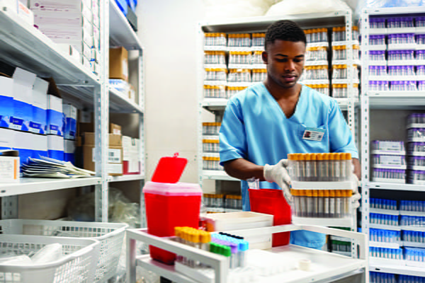 Man carrying test tubes.