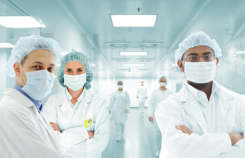 Several masked laboratorians posing for a picture