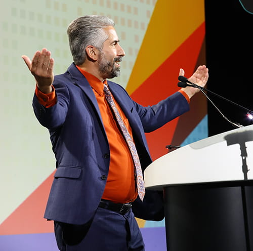 Paul J. Jannetto, PhD, DABCC, FADLM, standing at a podium with hands in the air.
