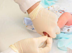 Newborn getting a shot