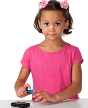Little girl testing blood sugar